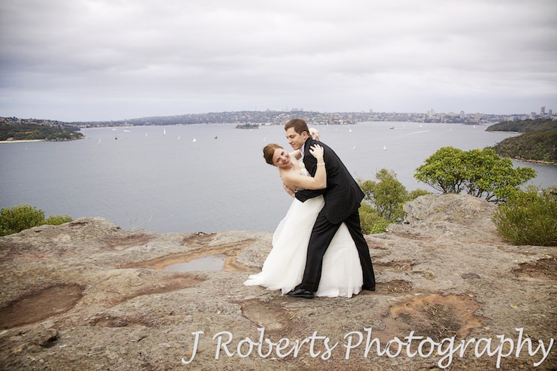 Bride and groom dipping on Georges Headland - wedding photography sydney